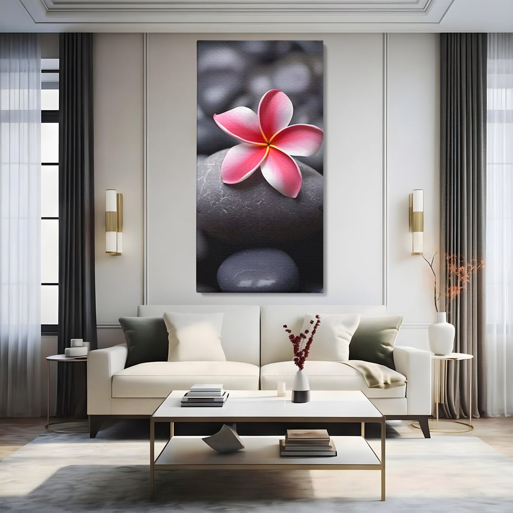 Tablou canvas cu floare roz pe pietre gri, fara rama, pe sasiu de lemn, pe perete intr-un living